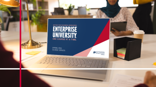 Laptop on a table with a Enterprise University Logo, Enterprise Bank & Trust