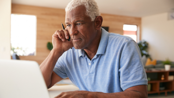 Older man sitting at computer