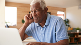 Older man sitting at computer