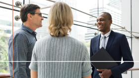 Couple having a conversation with businessman