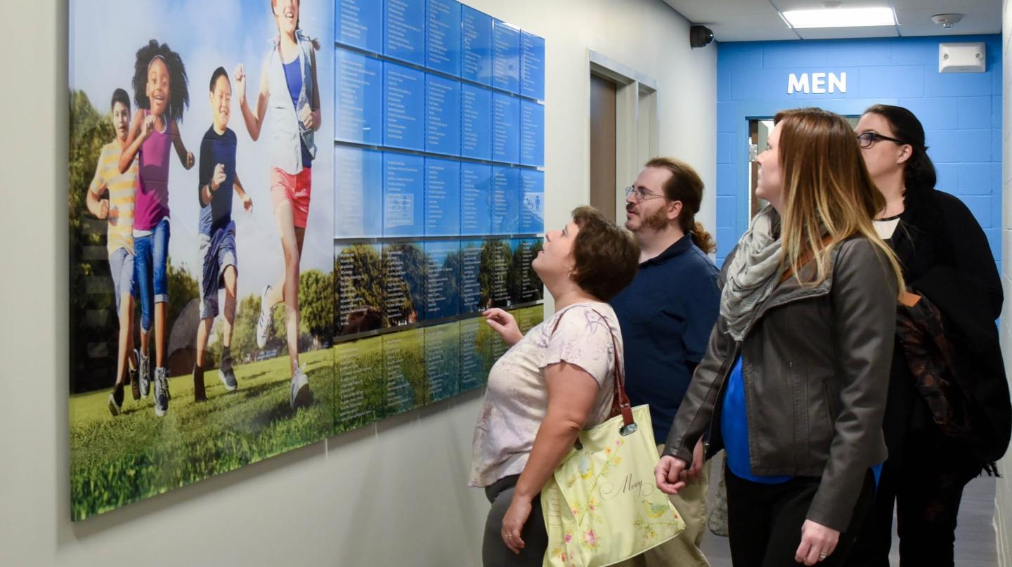 community members looking at Atchison YMCA programs