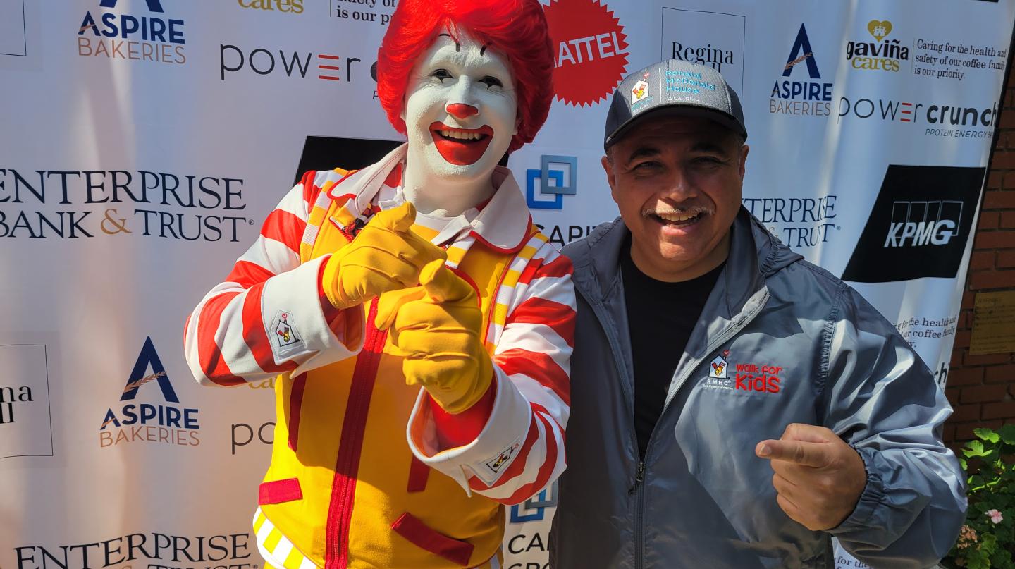 Ronald McDonald and man pose for picture